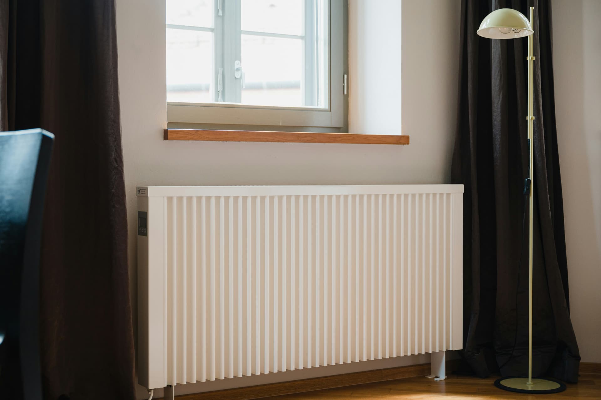 New radiator installed under a living room window in Liverpool