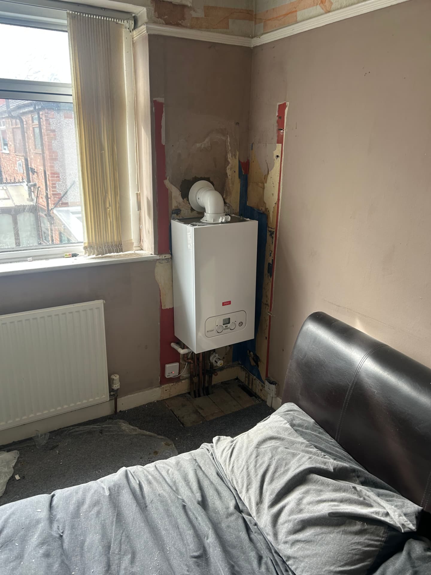 Replacement combi boiler fitted in a bedroom corner in Liverpool