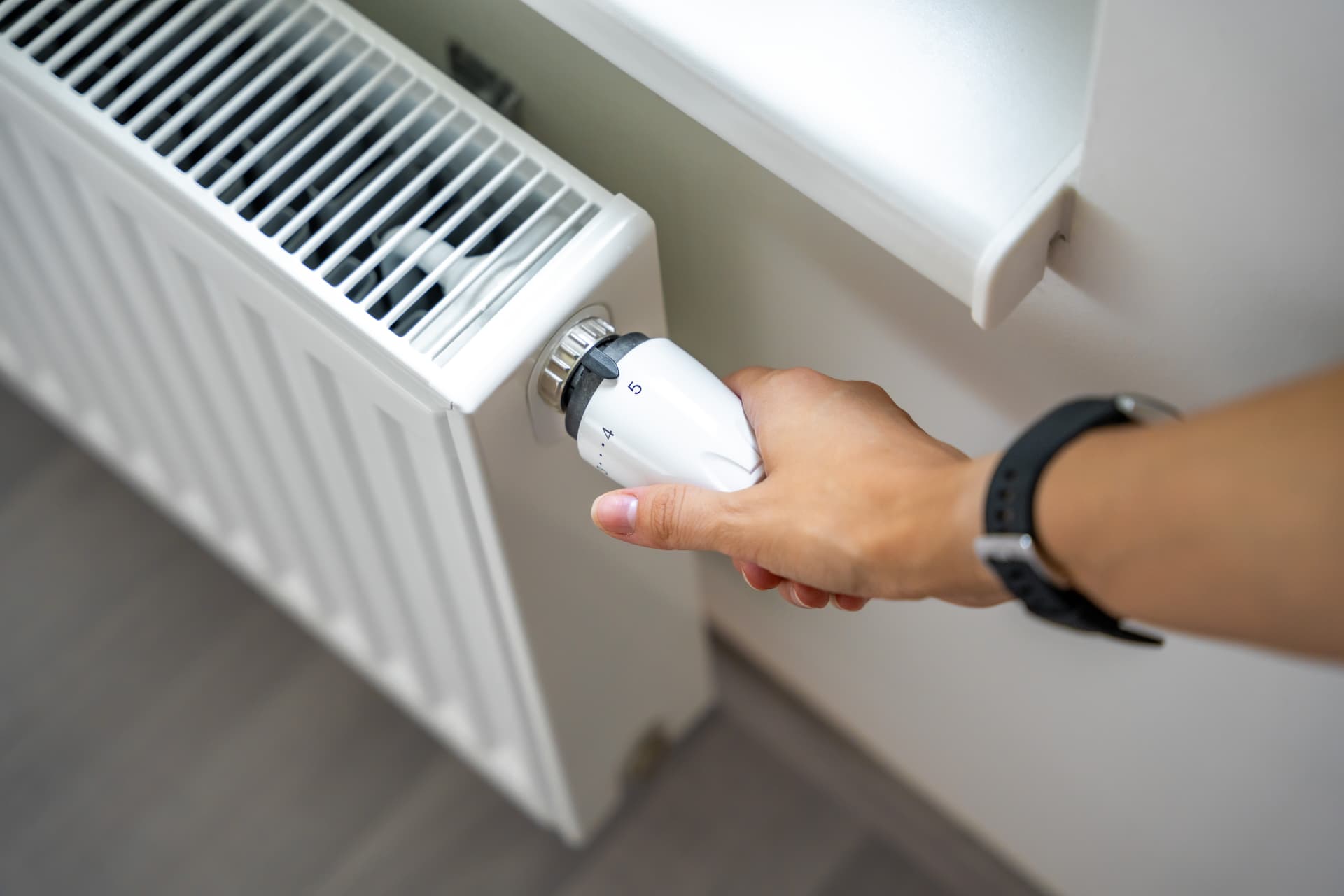 Thermostatic radiator valve being adjusted after a heating installation in Liverpool